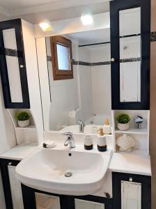 a white bathroom with a sink and a mirror at Private Villa Sea View BBQ in Epanomi +26 photos