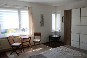 a bedroom with a bed and a table and chairs at Ferienwohnung in Reuterstadt Stavenhagen