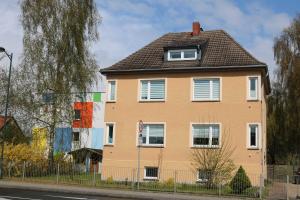 a large yellow house with a black roof at Ferienwohnung in Reuterstadt Stavenhagen
