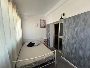 a small bedroom with a bed in a room at My Pradet in Le Pradet