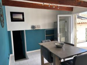 a dining room with a wooden table and chairs at My Pradet in Le Pradet +7 photos
