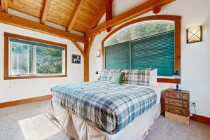 a bedroom with a bed and a large window at Bottle Bay Lakefront Lodge in Sandpoint
