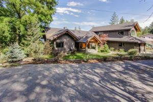 a house with a driveway in front of it at Bottle Bay Lakefront Lodge in Sandpoint