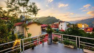 a balcony with a view of a city at Sapa Tatu Homestay in Sapa
