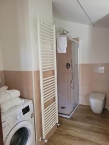 a washing machine in a bathroom with a shower at Bella Todi Apartment 2 in Todi