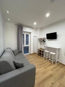 a living room with a couch and a table and a television at The Family Rooms, Rione alto, Zona ospedaliera in Naples