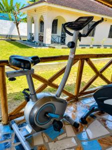 a exercise machine sitting on a table in front of a house at Eden Vista Stays in Dar es Salaam +5 photos