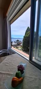a plate of vegetables on a table in front of a window at El encanto del lago in San Carlos de Bariloche +56 photos