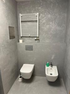 a bathroom with a white toilet and a sink at Apartament in the center of Poprad-free parking in Poprad +13 photos