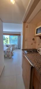 a room with a kitchen and a living room at El encanto del lago in San Carlos de Bariloche