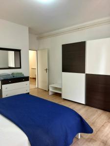 a bedroom with a large bed and a television at Apartment Park in Rabac