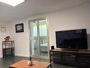 a living room with a large flat screen tv at My Pradet in Le Pradet