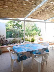 a table and chairs sitting on a patio at Casa SILMAGA in La Maddalena