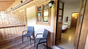 two chairs and a table in a room with a bedroom at iH Hotels Courmayeur Mont Blanc in Courmayeur +53 photos