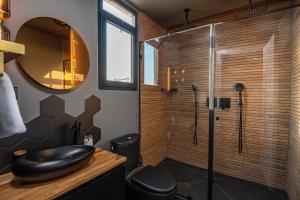a bathroom with a shower with a sink and a mirror at yoga Lake view in Had Nes +64 photos
