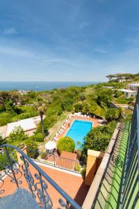 a balcony with a view of a pool and the ocean at Hotel Monti in Casamicciola Terme