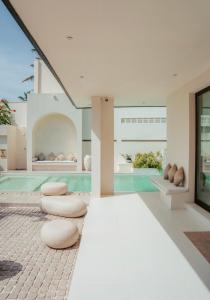 a house with a swimming pool with stools at Salt & Palm Villa in Maggona West