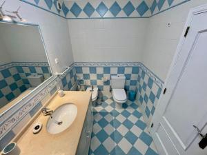 a bathroom with a sink and a toilet at Milfontes Villa in Vila Nova de Milfontes