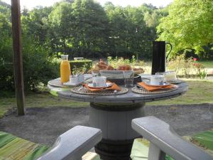 a table with food and drinks on top of it at Karibu Normandy-Maasai in Lisieux