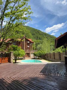a backyard with a swimming pool and a house at PRINCE Villa in Shaian