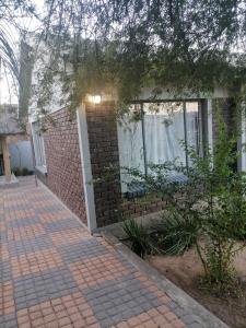 a brick house with a brick walkway at Imvumbu Guest House in Nelspruit