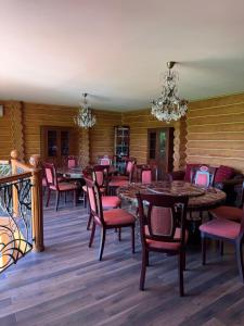 a dining room with tables and chairs and chandeliers at PRINCE Villa in Shaian