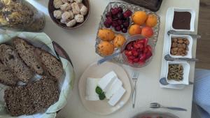 a table topped with different types of bread and other foods at Amati Bed & Breakfast in Lecce +10 photos