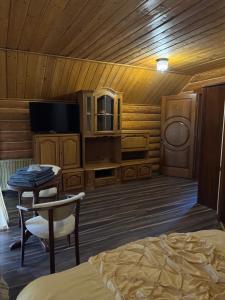 a bedroom with a bed and a tv and a table at PRINCE Villa in Shaian