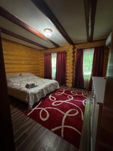 a bedroom with a bed and a red rug at PRINCE Villa in Shaian +39 photos