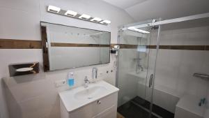 a white bathroom with a sink and a shower at Hasi-Stübchen in Geldern