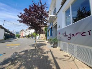 a building with a sign on the side of a street at Hotel Vilagarcia in Vilagarcia de Arousa