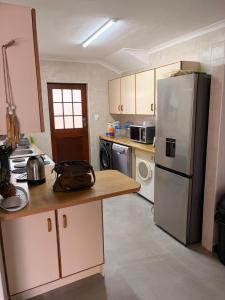 a kitchen with a refrigerator and a counter top at River & Salt at Stilbaai in Stilbaai-Oos