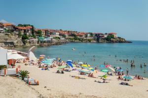 a group of people on a beach in the water at Apart-Hotel Onegin & Thermal Zone in Sozopol