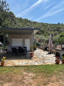 a patio with a table and chairs on it at Elision in Skala Marion