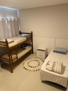 a bedroom with two bunk beds and a rug at Espaço MGS in Foz do Iguaçu +23 photos