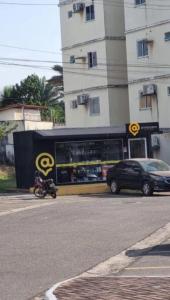 a scooter parked in front of a store on a street at AP da Vicky 2 quartos central São Luis in São Luís