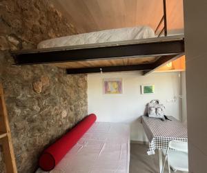 a bedroom with a red bed and a table at Alojamiento Colinas in Monachil +58 photos