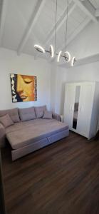 a bedroom with a bed and a painting on the wall at Home Dimitra in Grammatikiánoi