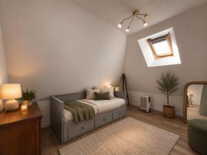 a bedroom with a bed and a mirror at Ecolocs Caen Beuville in Caen