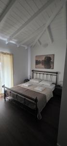 a bedroom with a large bed in a room at Home Dimitra in Grammatikiánoi