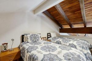 a bedroom with two beds and a wooden ceiling at Western Welcome in Sun Valley +39 photos
