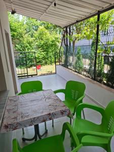 a table and chairs on a balcony with a table and chairs at Laboti Quiet Room in Librazhd +11 photos