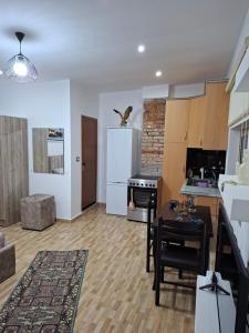 a kitchen with a table and a white refrigerator at Laboti Quiet Room in Librazhd