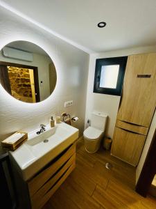a bathroom with a sink and a toilet and a mirror at Casa Cazorla in Ojén +13 photos