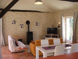a living room with a couch and a table at La Zénitude in Les Lèches