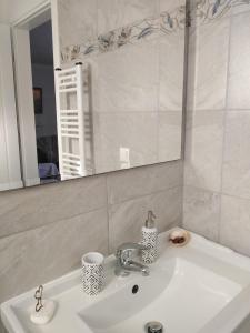 a bathroom sink with a mirror and a sink at Nostalgia Apartments B Plus in Sami 50 meters from the sea in Sami +60 photos