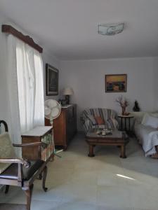 a living room with a couch and a table at Nostalgia Apartments B Plus in Sami 50 meters from the sea in Sami