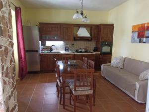 a kitchen and living room with a table and a couch at Casa Maria in Matzaccara