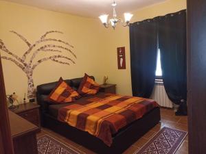 a bedroom with a bed with blue curtains and a tree at Casa Maria in Matzaccara