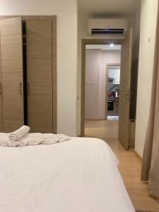 a bedroom with a white bed and a kitchen at Prestigia Marrakech in Inezgane